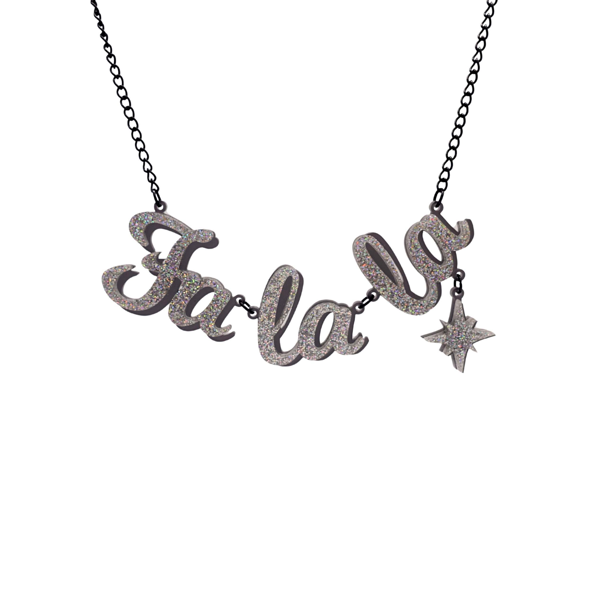 Fa La LA necklace in silver glitter,  with hanging vintage star, shown hanging against a white background. Designed by Sarah Day for the Christmas Collection. 