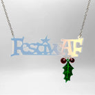 Festive AF matte iridescent necklace with hanging holly leaf and berries, shown hanging on a stainless steel chain against a white background. 