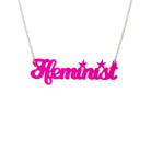 Welsh Ffeminist necklace in neon pink, shown hanging against a white background. 