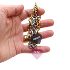 My hand holding the charm bracelets in stainless steel and gold with two charms. 