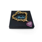 Gold PVD vacuum plated charm bracelet with a pink Hold Fast charm. 