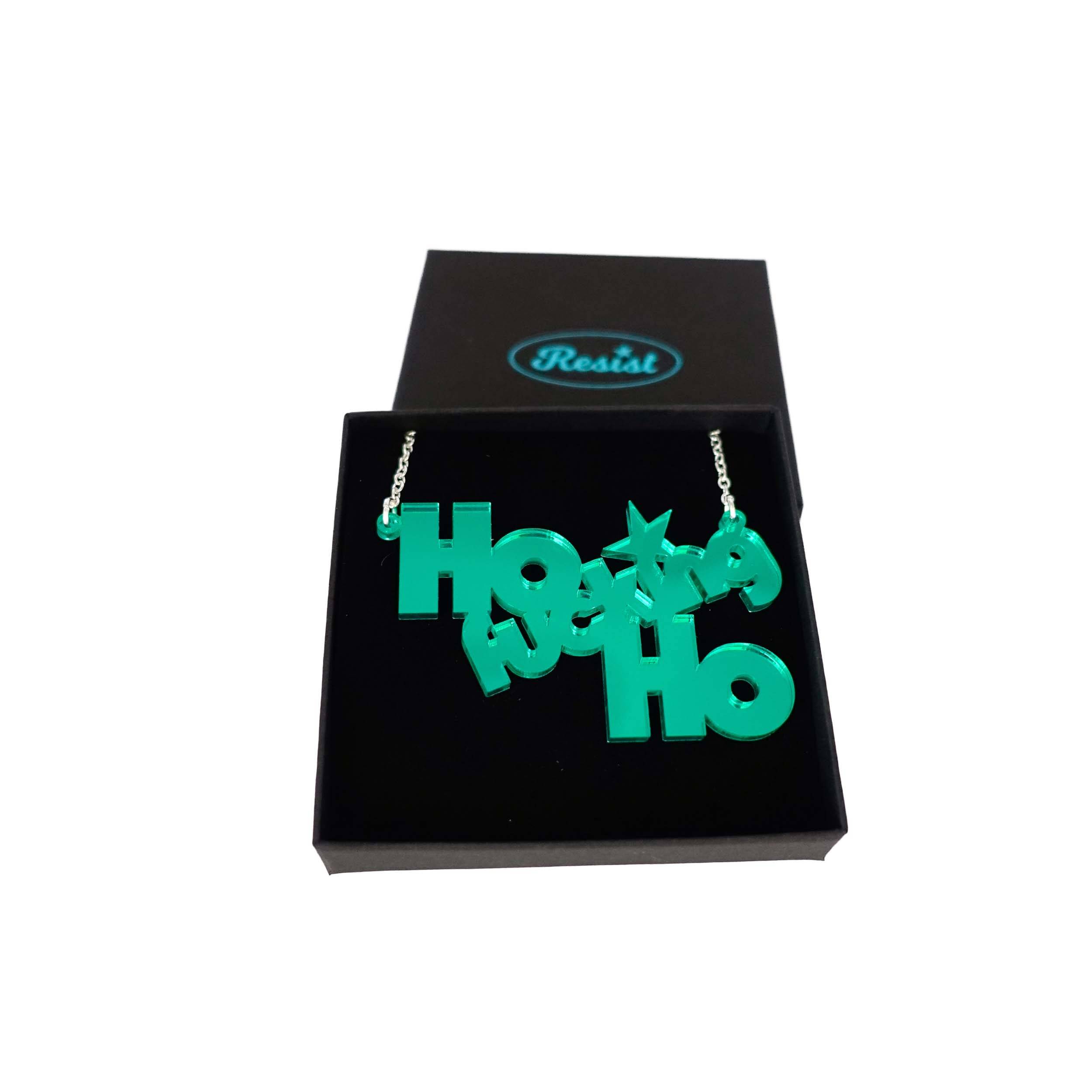 Ho F*cking Ho necklace in electric green mirror, shown in a Wear and Resist gift box. 