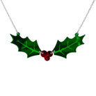 Naturalist Holly necklace with two holly leavs joined by a trio of red berries in mirror acrylic, shown hanging on a stainless steel chain against a white background. 