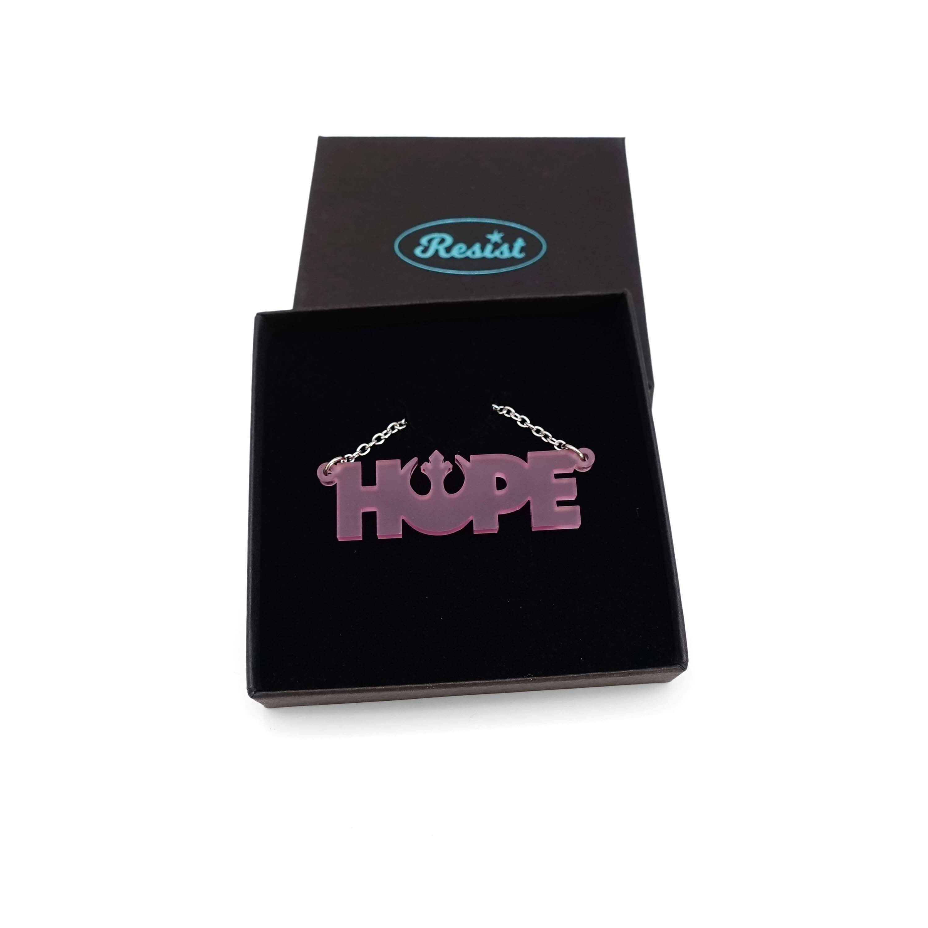 Hope necklace with Rebel Alliance symbol in pale pink frost, shown in a Wear and Resist gift box. 