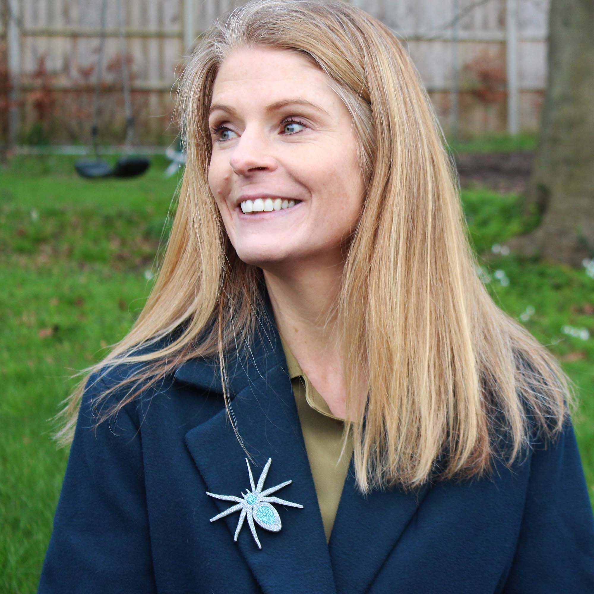 Sarah Day, the founder of Wear and Resist wears a spider brooch