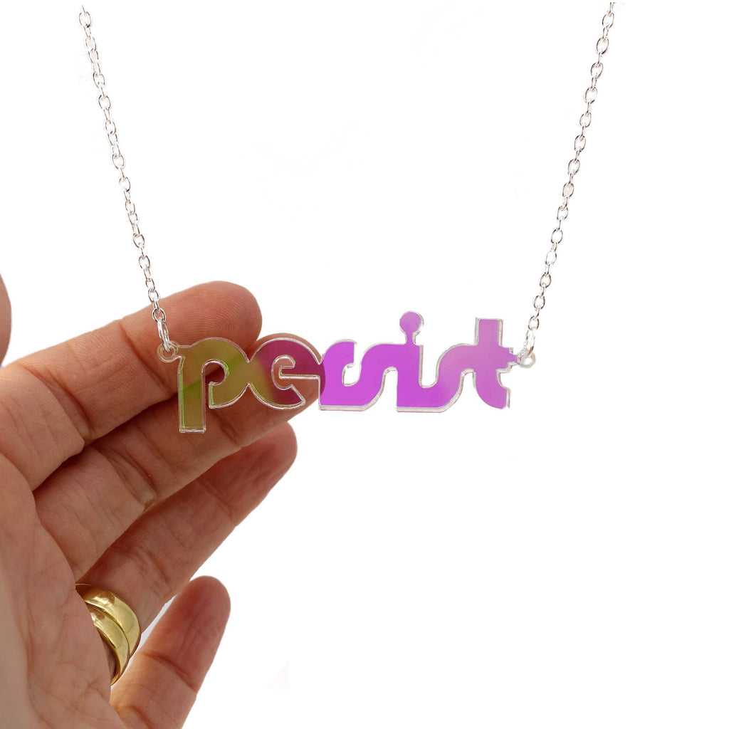 Iridescent disco Persist necklace shown hanging against a white background. 