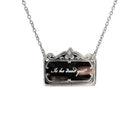 A necklace etched with the words, 'is he dead yet?' shown hanging on a stainless steel chain. 