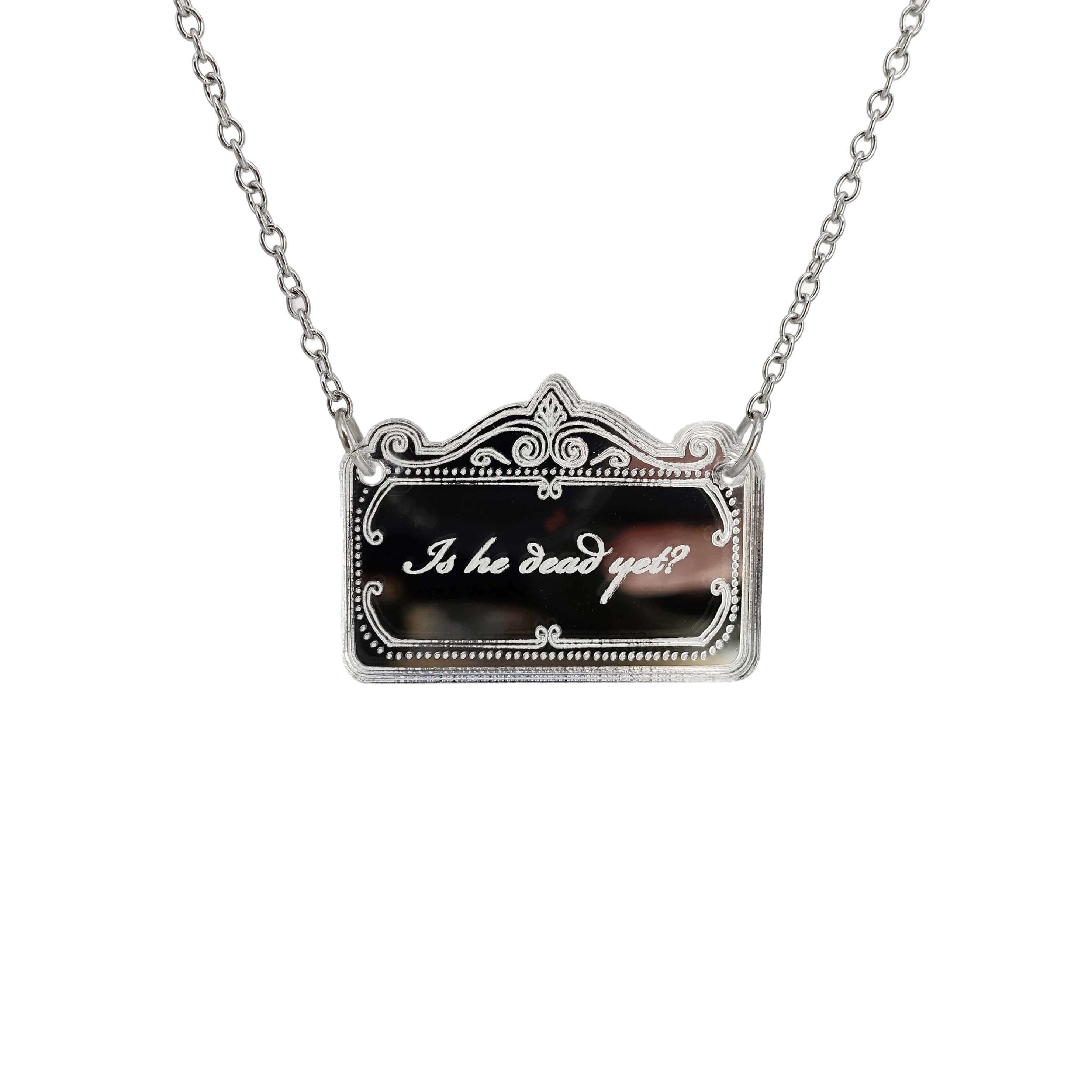 A necklace etched with the words, 'is he dead yet?' shown hanging on a stainless steel chain. 