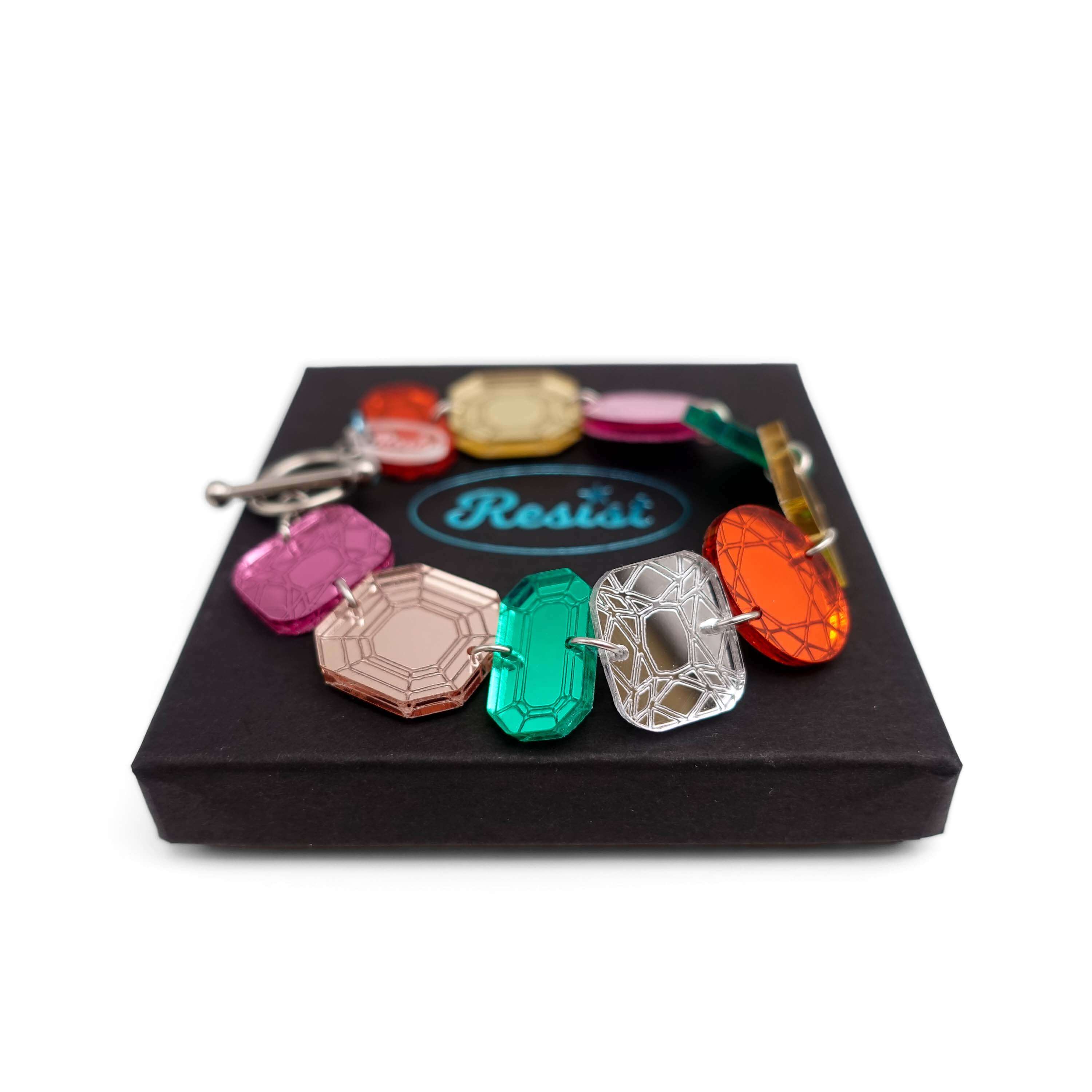 Jewel bracelet with stainless steel toggle clasp shown fastened on a Wear and Resist gift box.