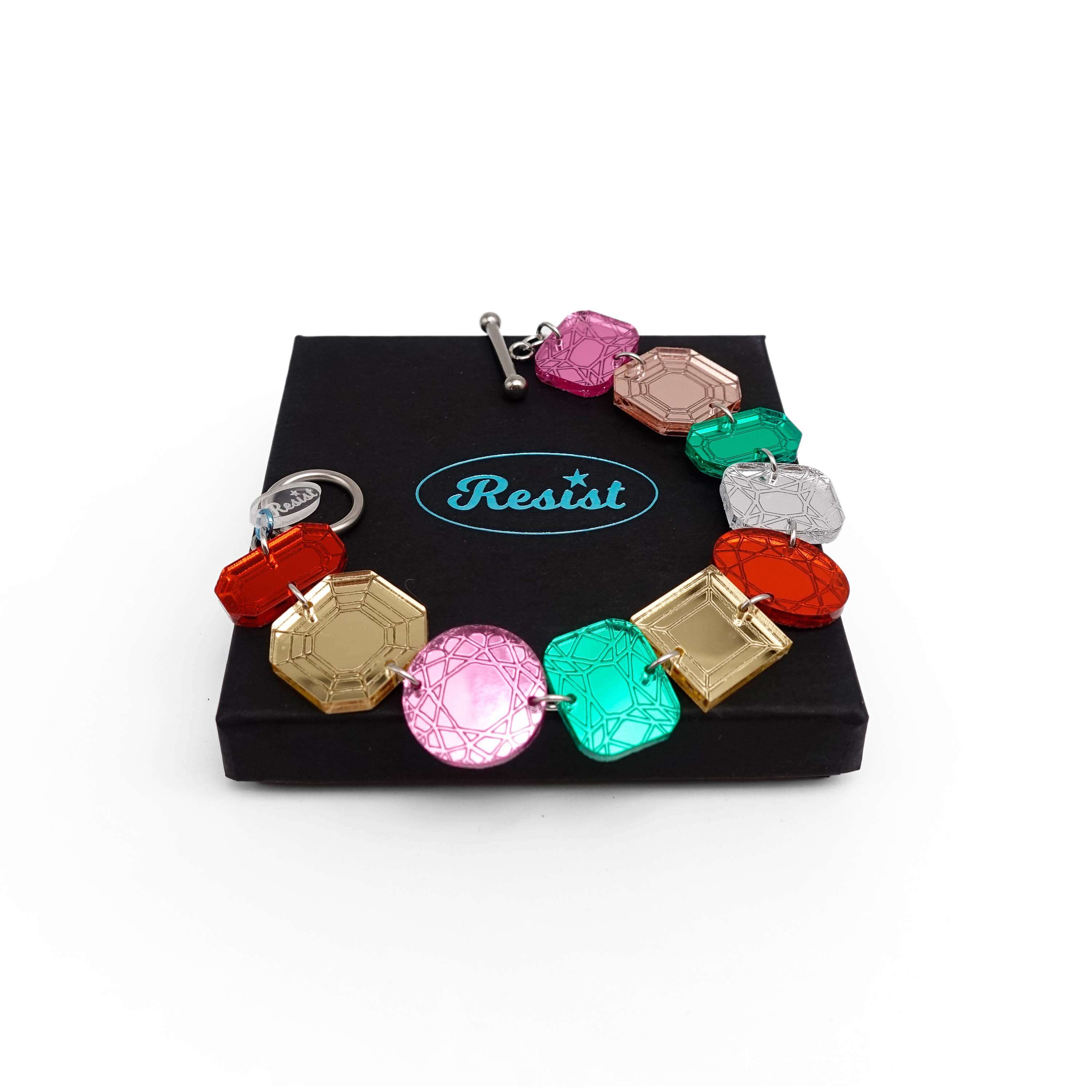 Jewel bracelet with stainless steel toggle clasp shown open on a Wear and Resist gift box.