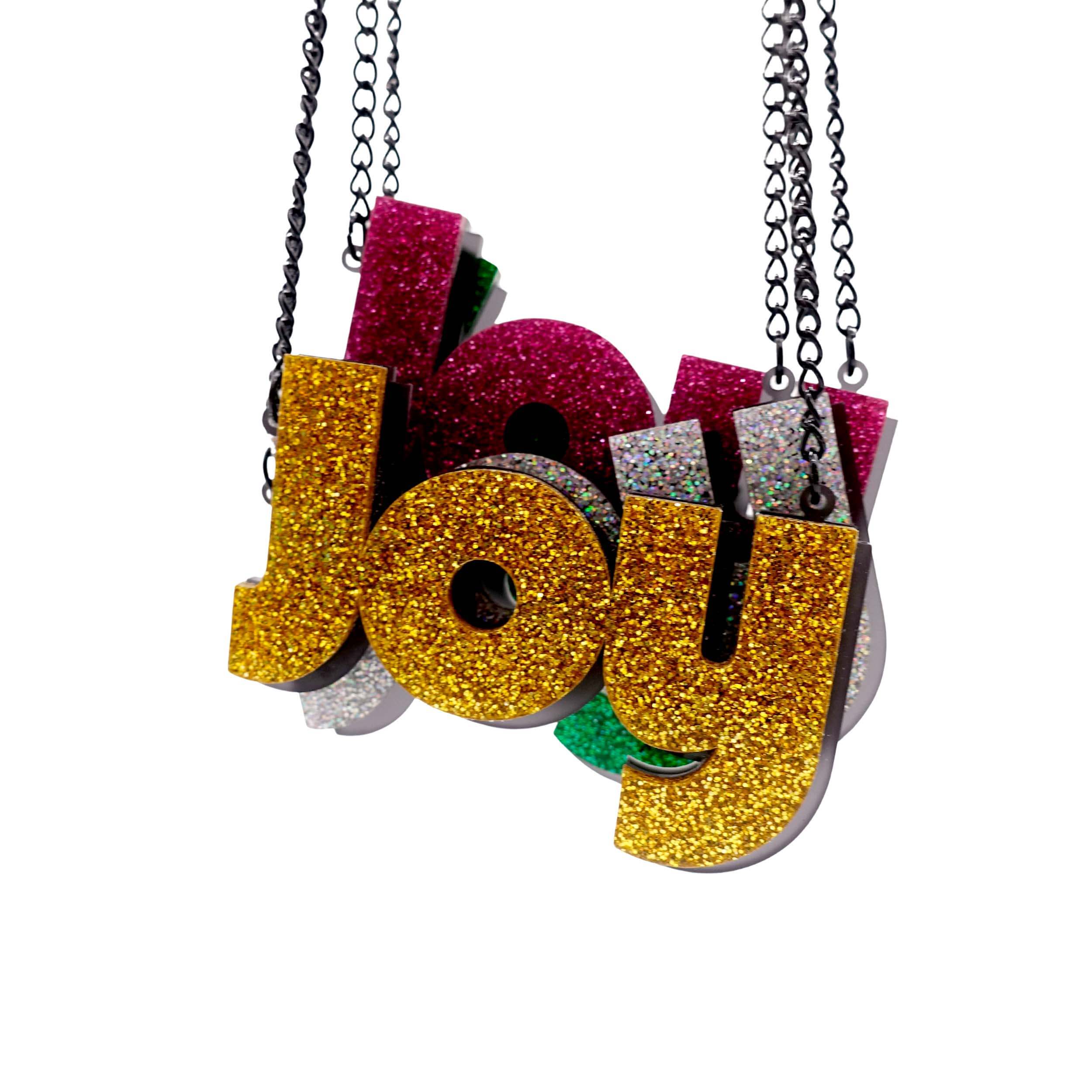 All four colours of Joy statement necklaces, shown hanging against a white background, with ultra gold in front. 