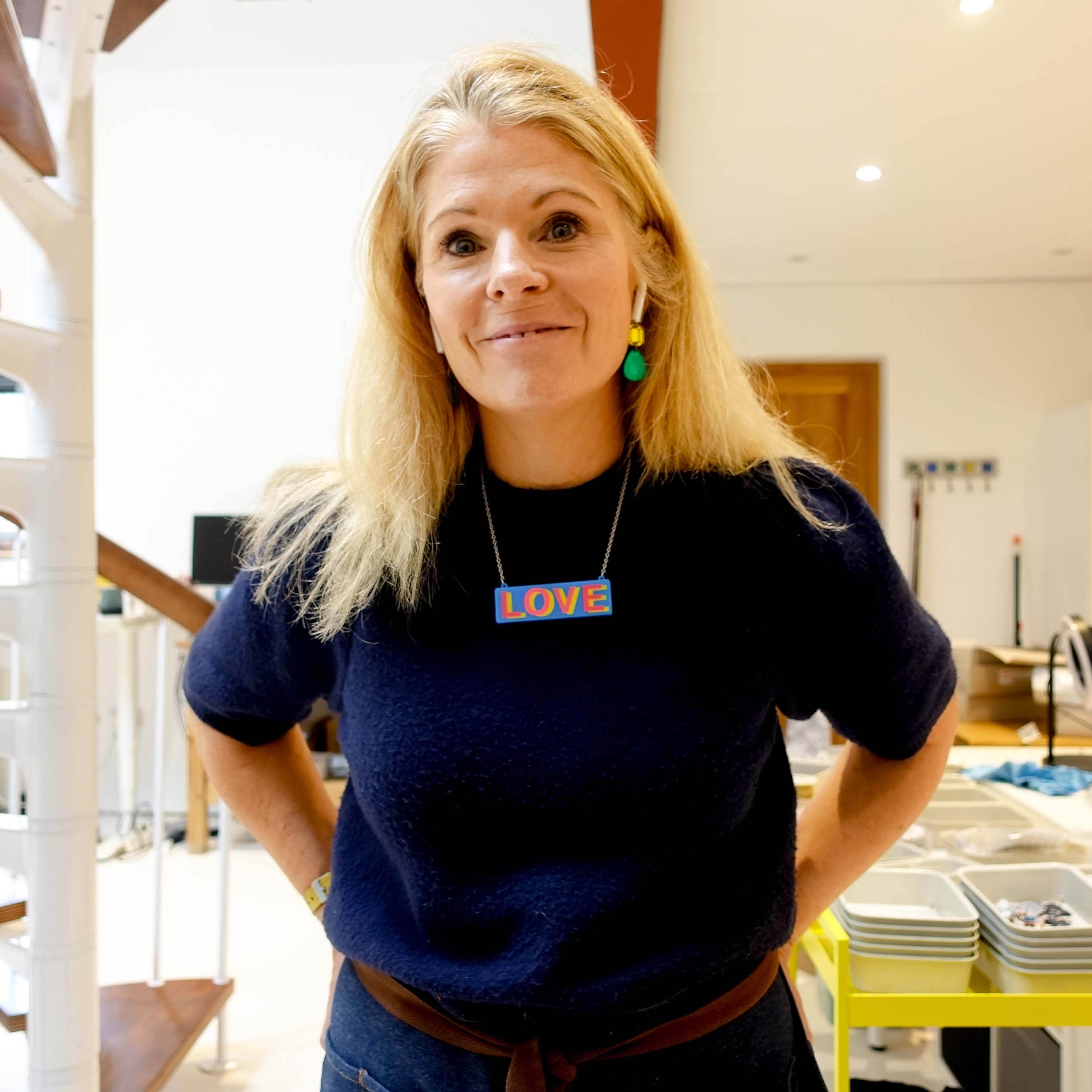 Sarah Day wears the LOVE necklace in her studio. 