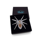 The All Hail Lady Hail Spider brooch shown in a Wear and Resist gift box. 