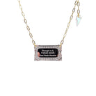 Literary Quote necklace etched with a quote by Zora Neale Hurston, 'Through it all, I am myself.' Shown on a gold plated paperclip chain finished with an iridescent lightning bolt, hanging against a white background. 