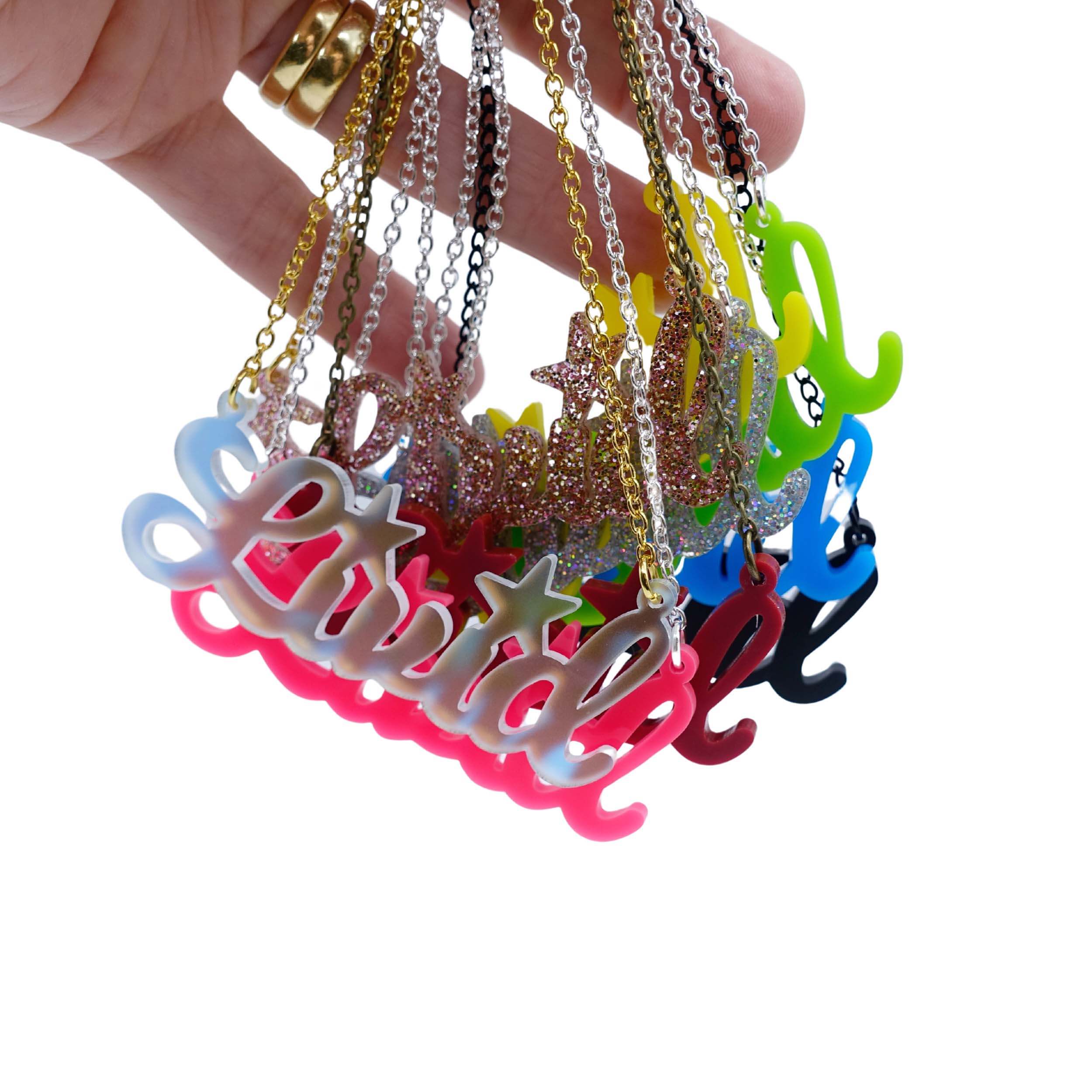 A group of Livid necklaces in new colours shown held up in my hand against a white background. 