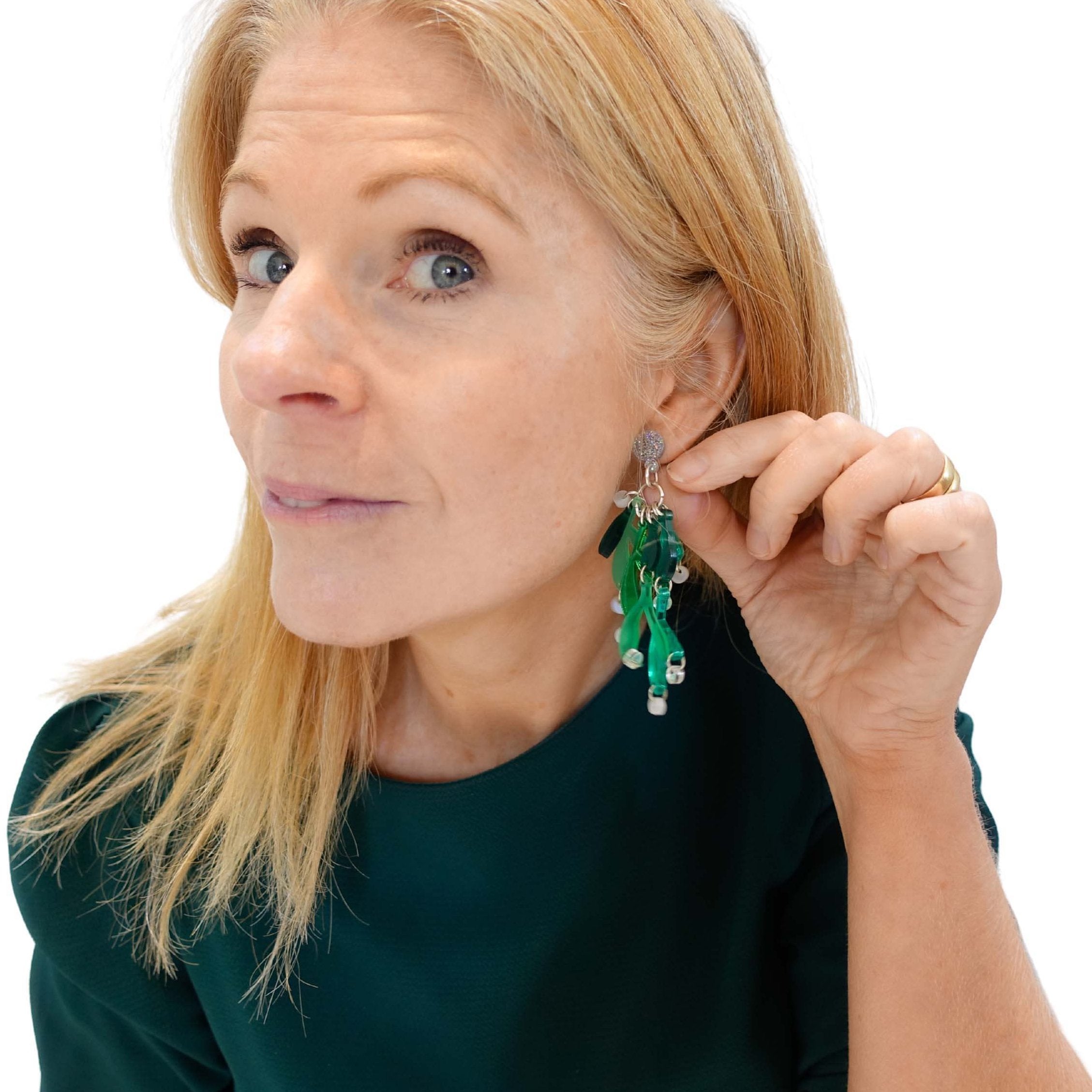 Sarah Day, founder of Wear and Resist wears Mistletoe earrings.