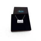 Nah necklace in silver mirror on a stainless steel chain shown in a Wear and Resist gift box. 