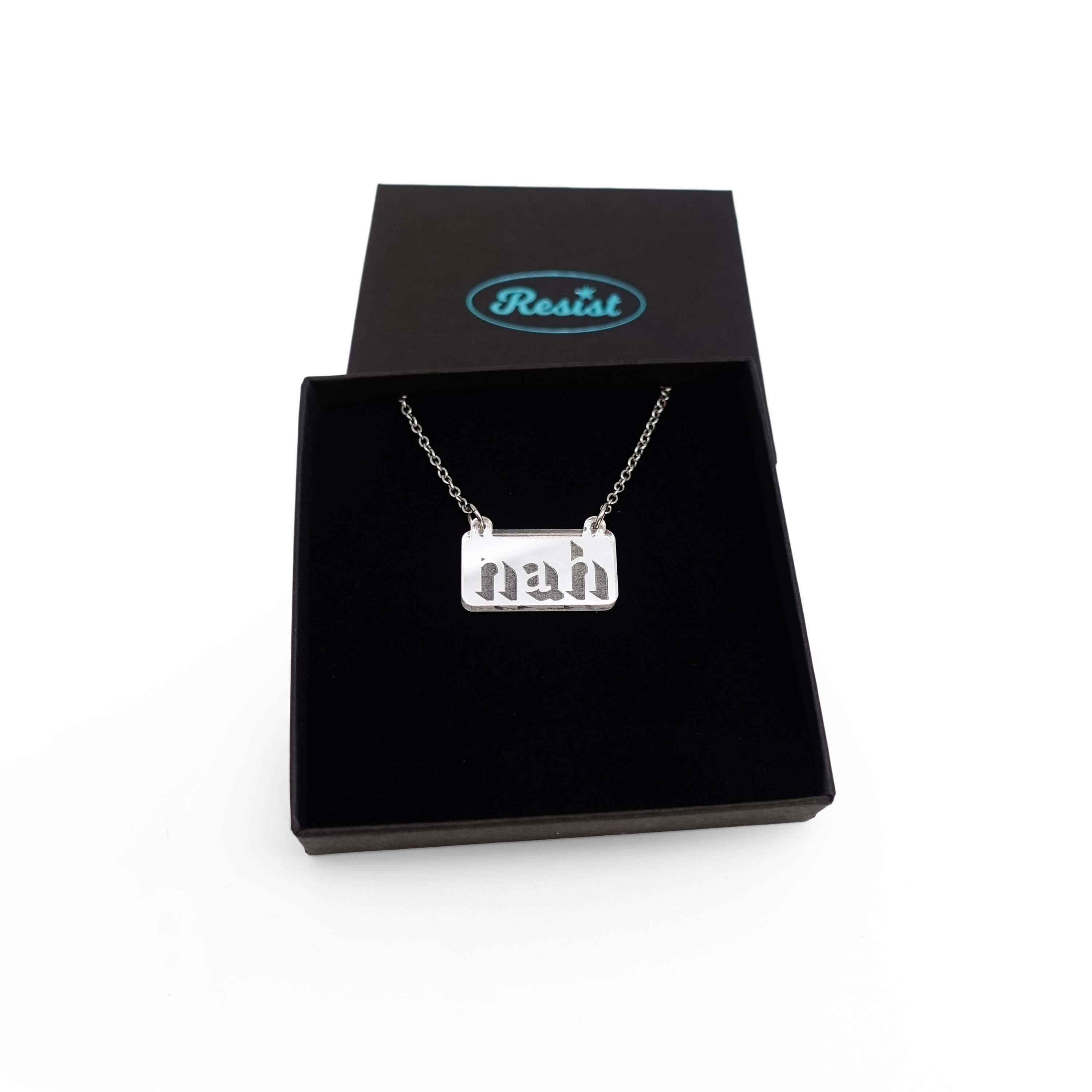 Nah necklace in silver mirror on a stainless steel chain shown in a Wear and Resist gift box. 