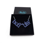 Welsh sweary Nefi blw (navy blue!) necklace shown in a Wear & Resist gift box. 
