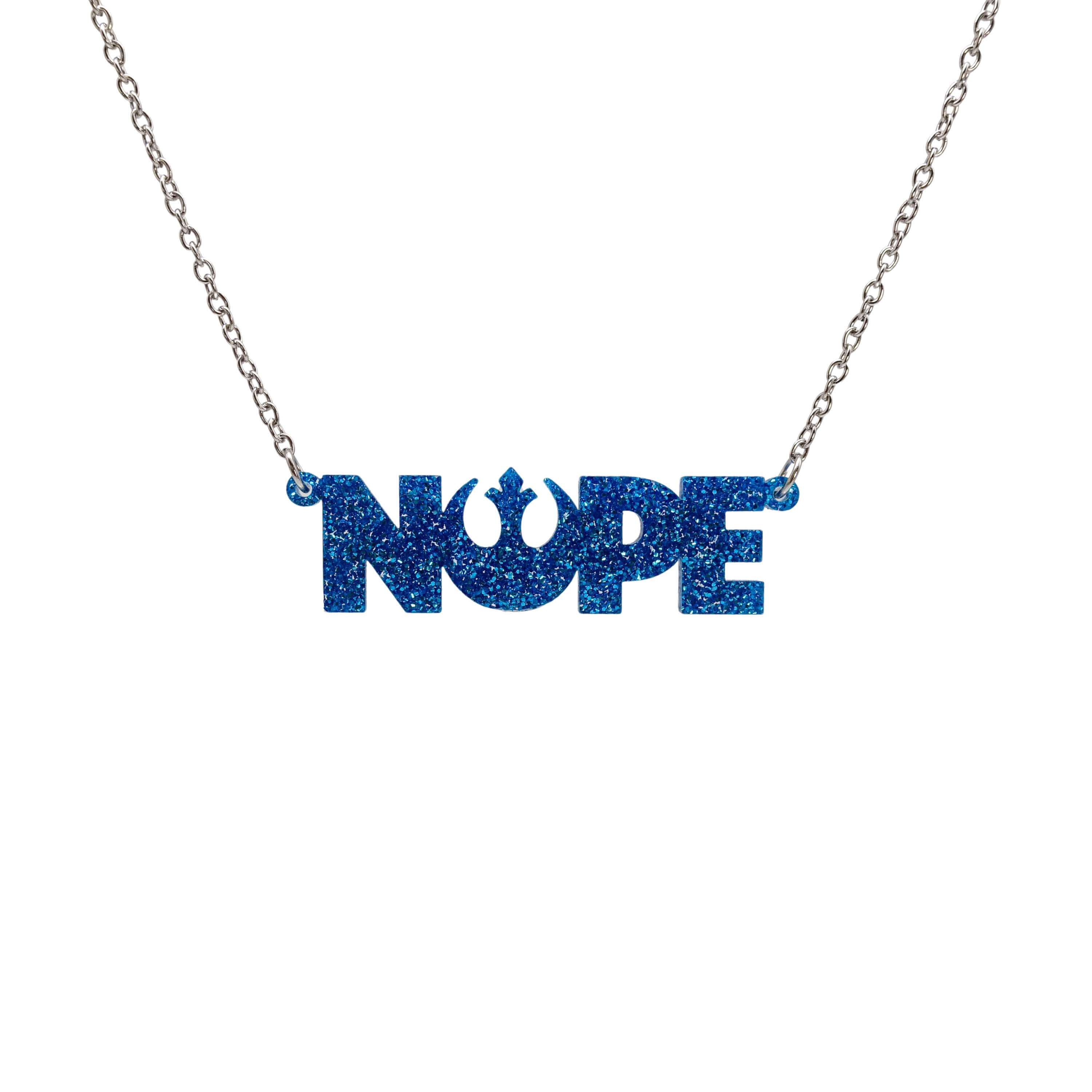 Nope necklace with Rebel Alliance symbol in blue glitter hanging on a stainless steel chain against a white background. 