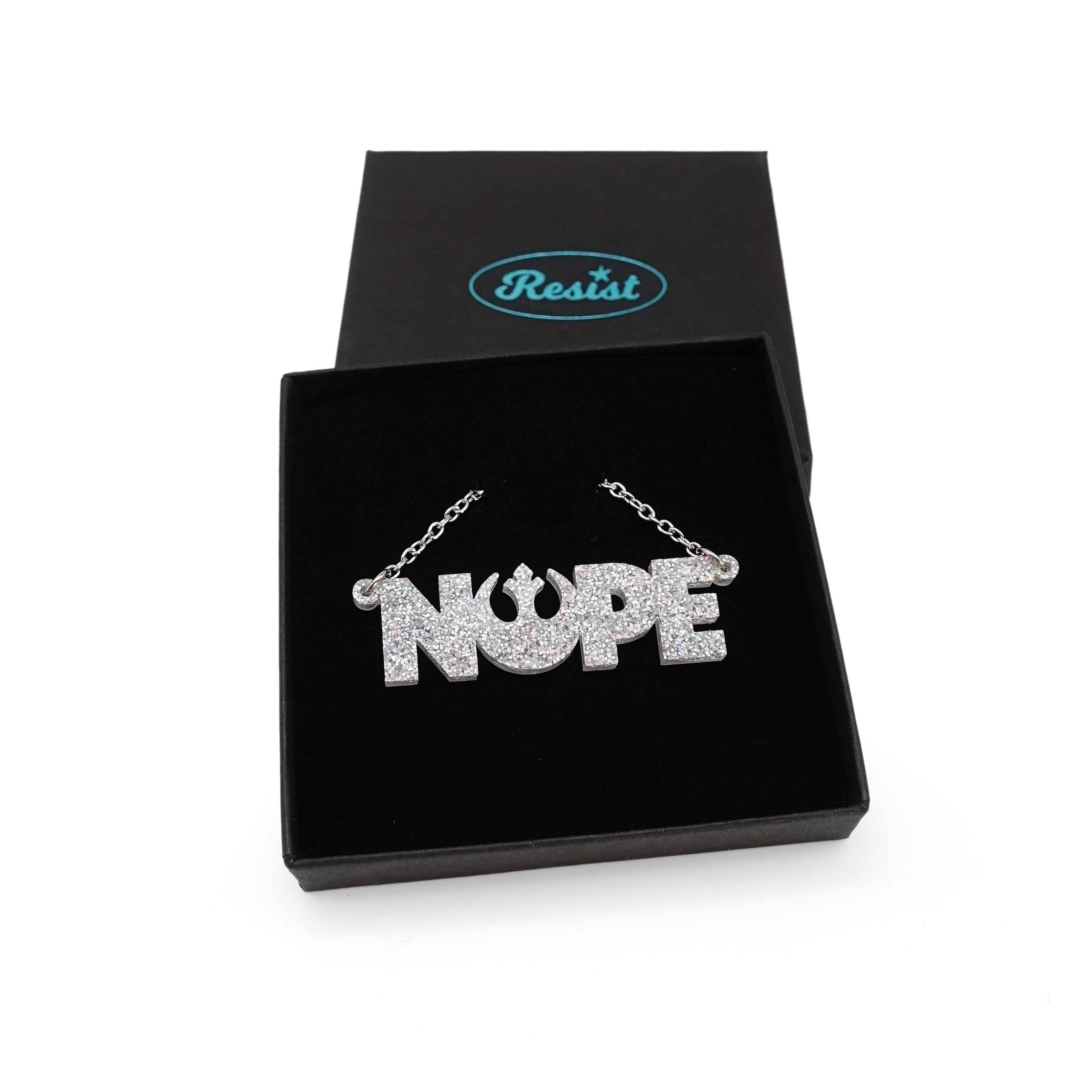 Nope necklace with Rebel Alliance symbol in silver glitter, shown in a Wear and Resist gift box. 
