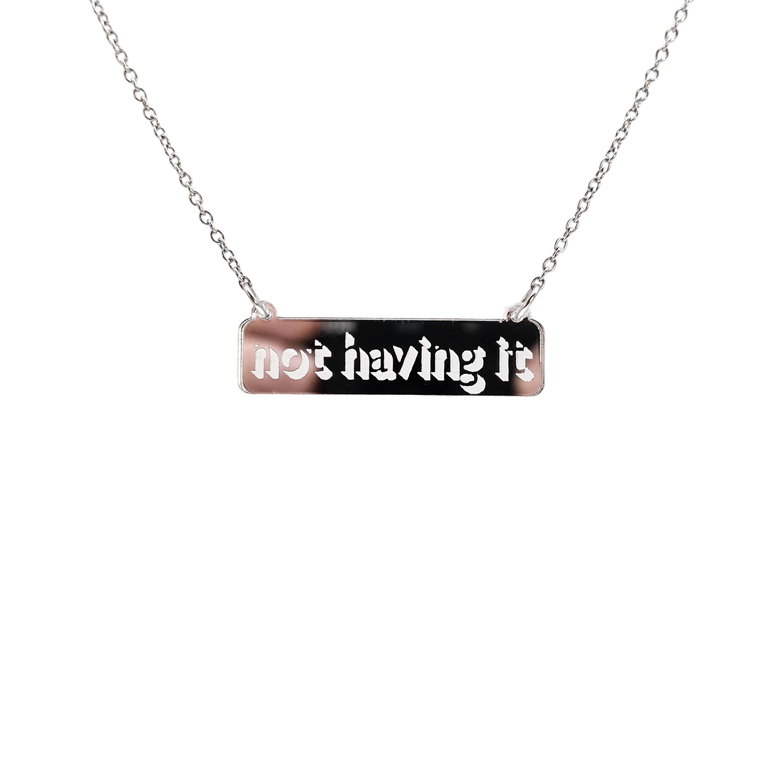 Not Having It necklace in silver mirror on a stainless steel chain hanging against a white background. 