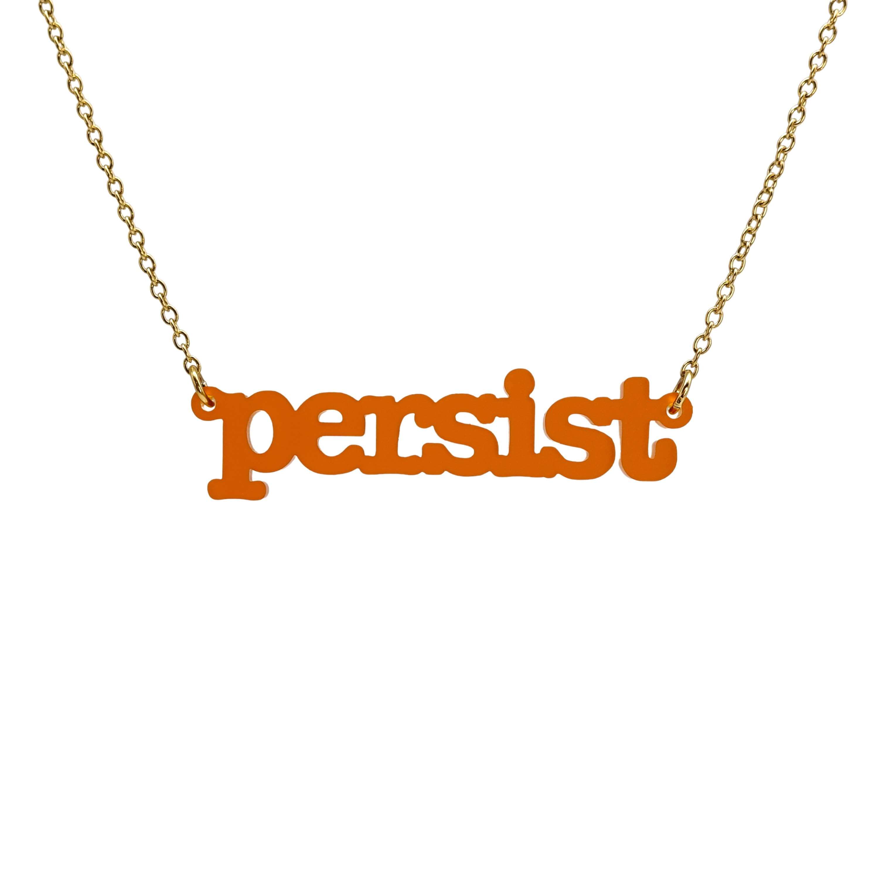 Typewriter Resist necklace in cider frost shown hanging on a gold plated stainless steel chain against a white background. 