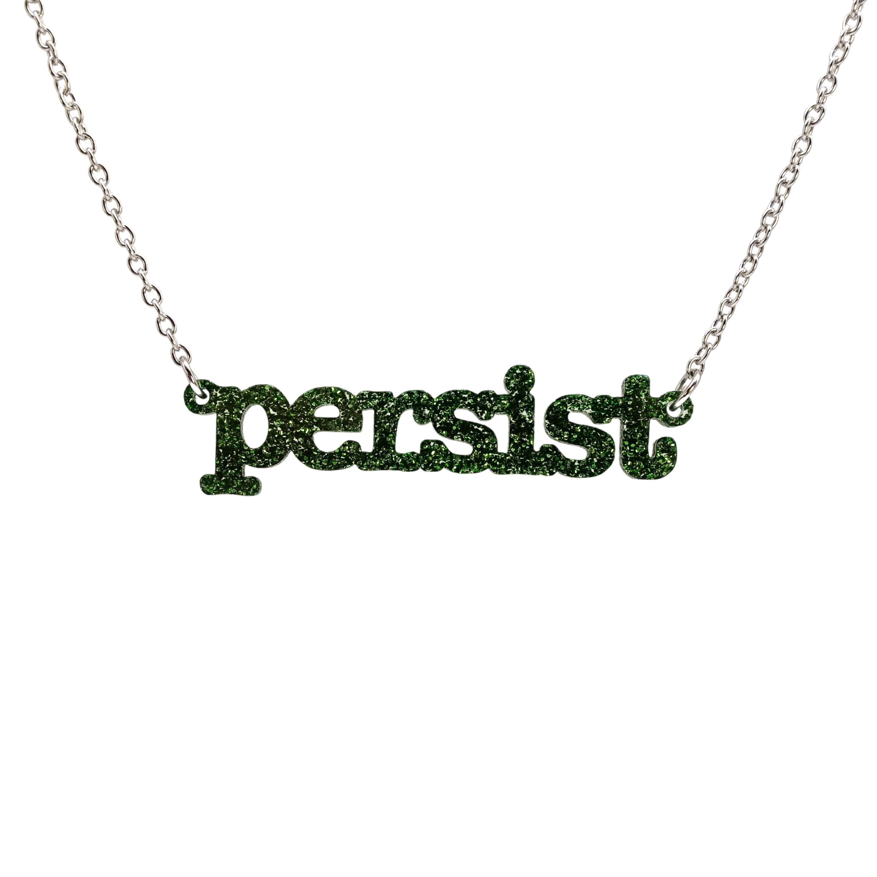Typewriter Resist necklace in moss glitter shown hanging on a stainless steel chain against a white background. 