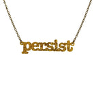 Typewriter Resist necklace in ultra gold glitter shown hanging on an antique gold chain against a white background. 