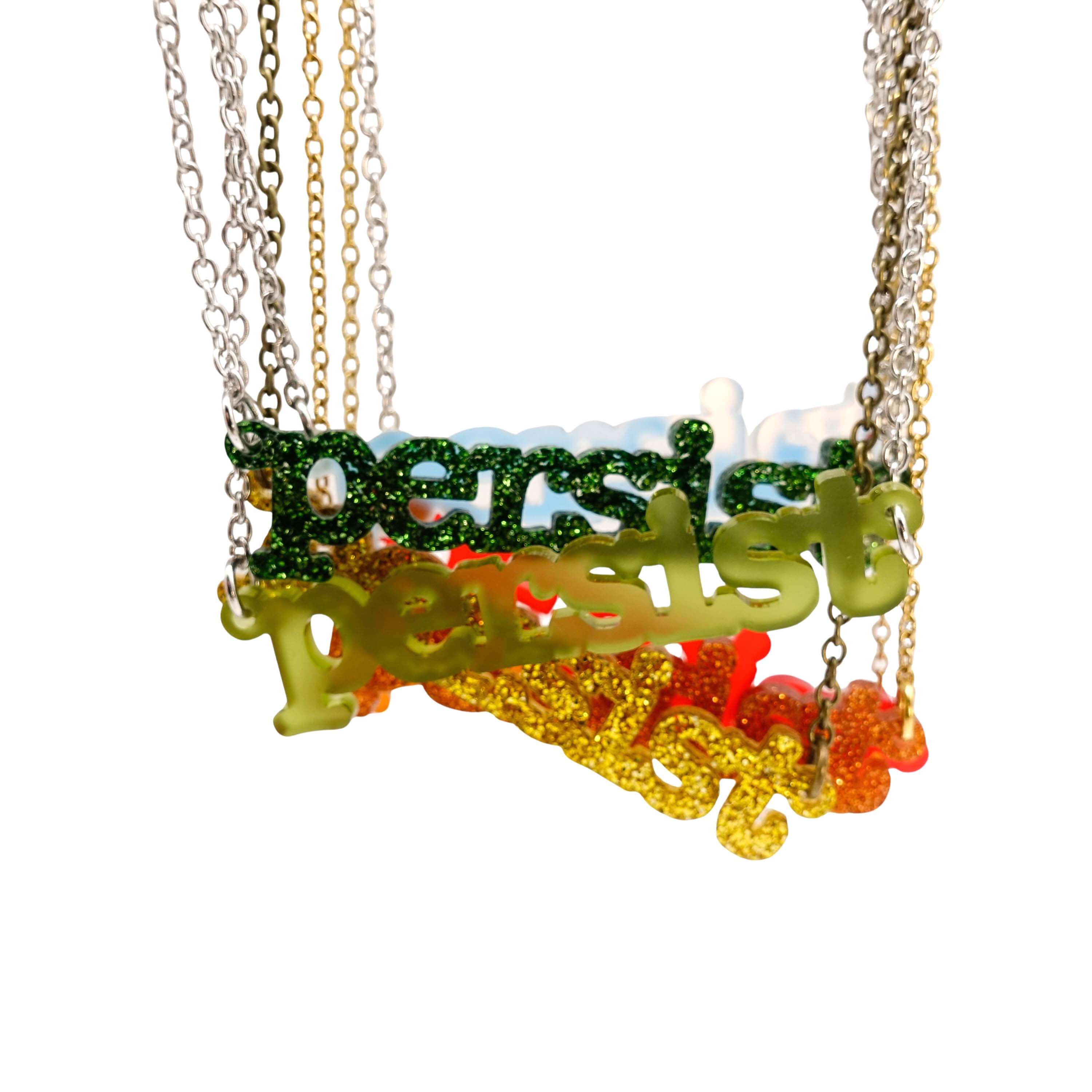 Typewriter persist necklaces in new Autumn colours shown hanging together against a white background. 