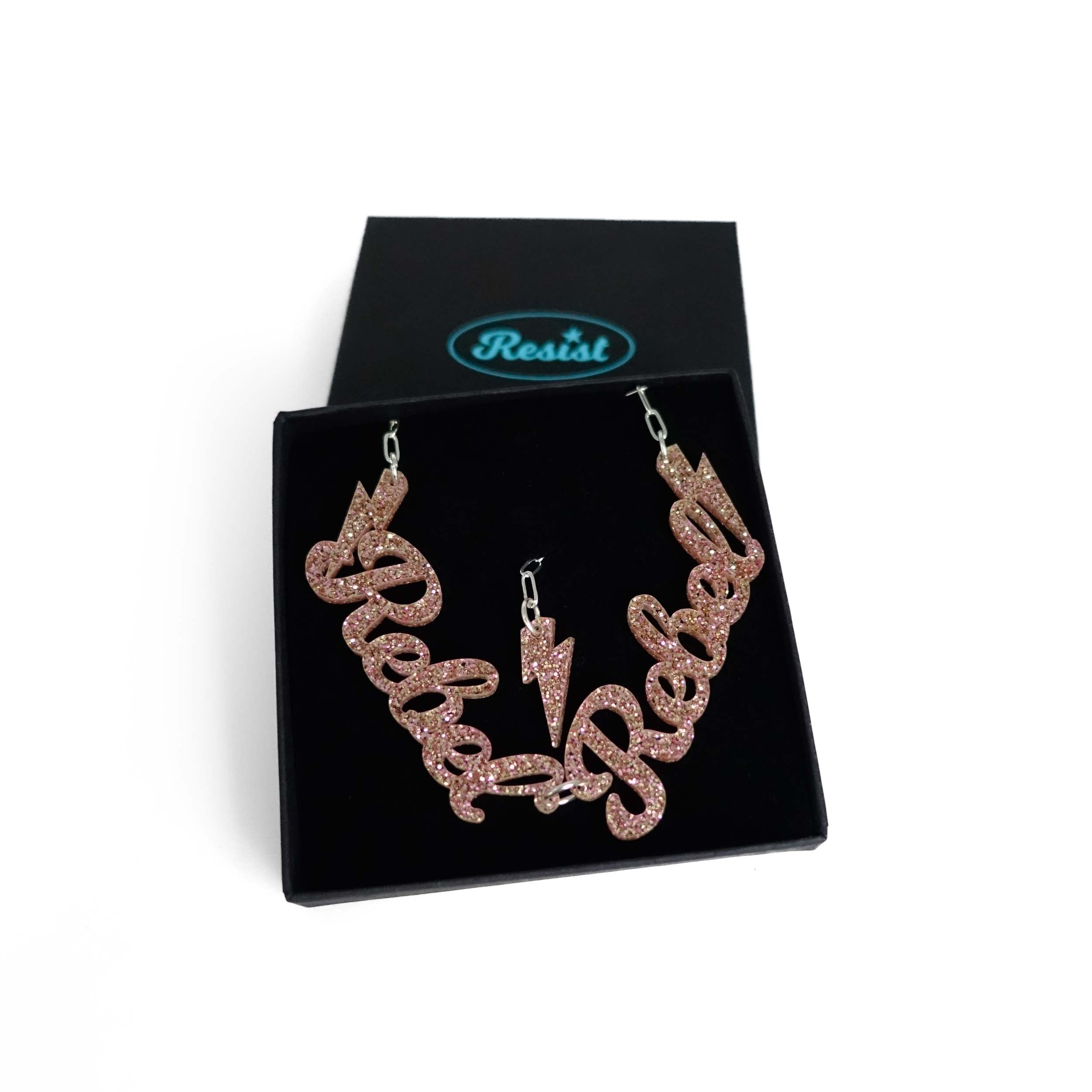 Champagne glitter Rebel Rebel necklace shown in a Wear and Resist gift box. 
