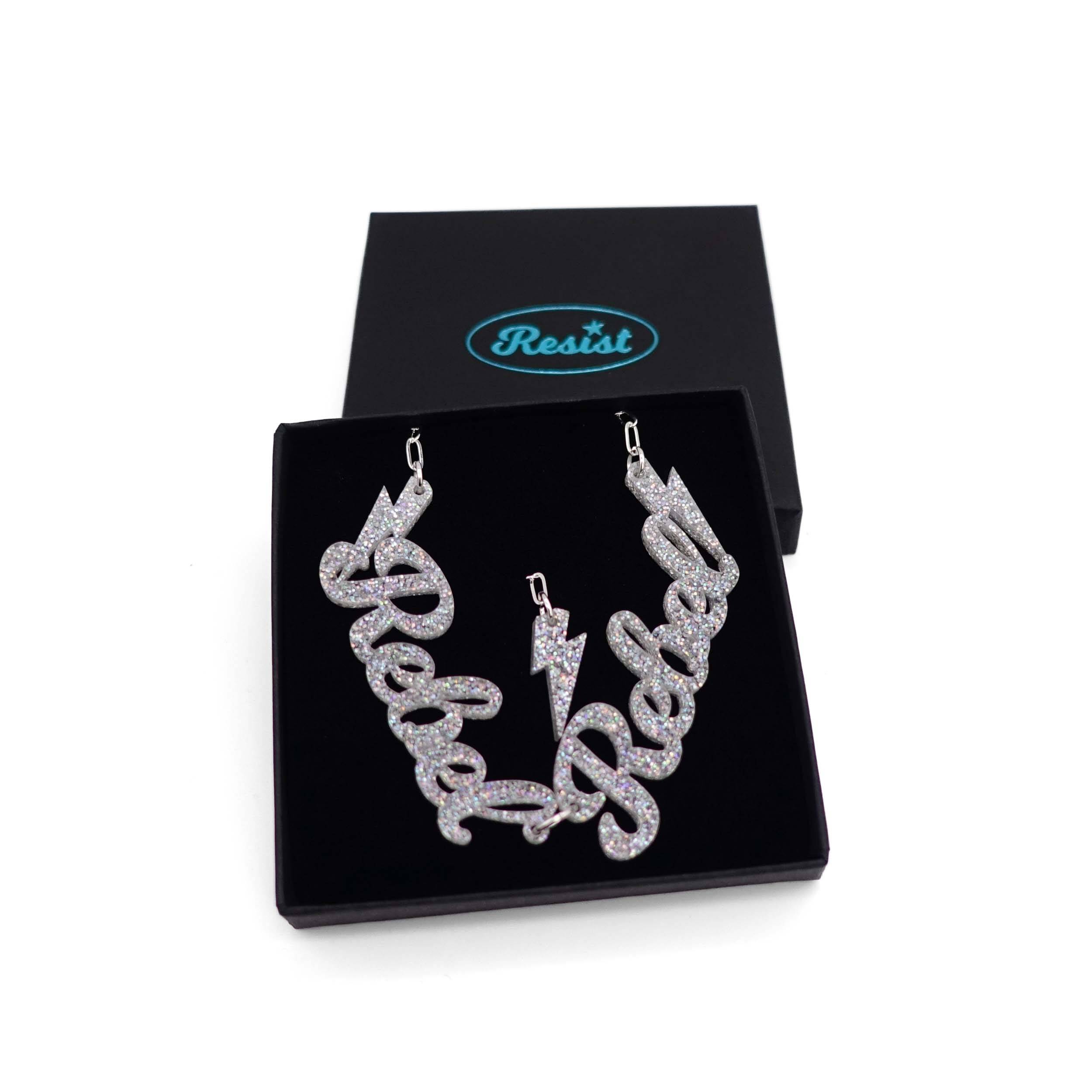 Silver glitter Rebel Rebel necklace shown in a Wear and Resist gift box. 