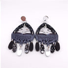 Western style Resist and Persist statement dangly earrings in black and silvere.