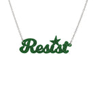 Resist necklace in green glitter, shown hanging against a white background. 