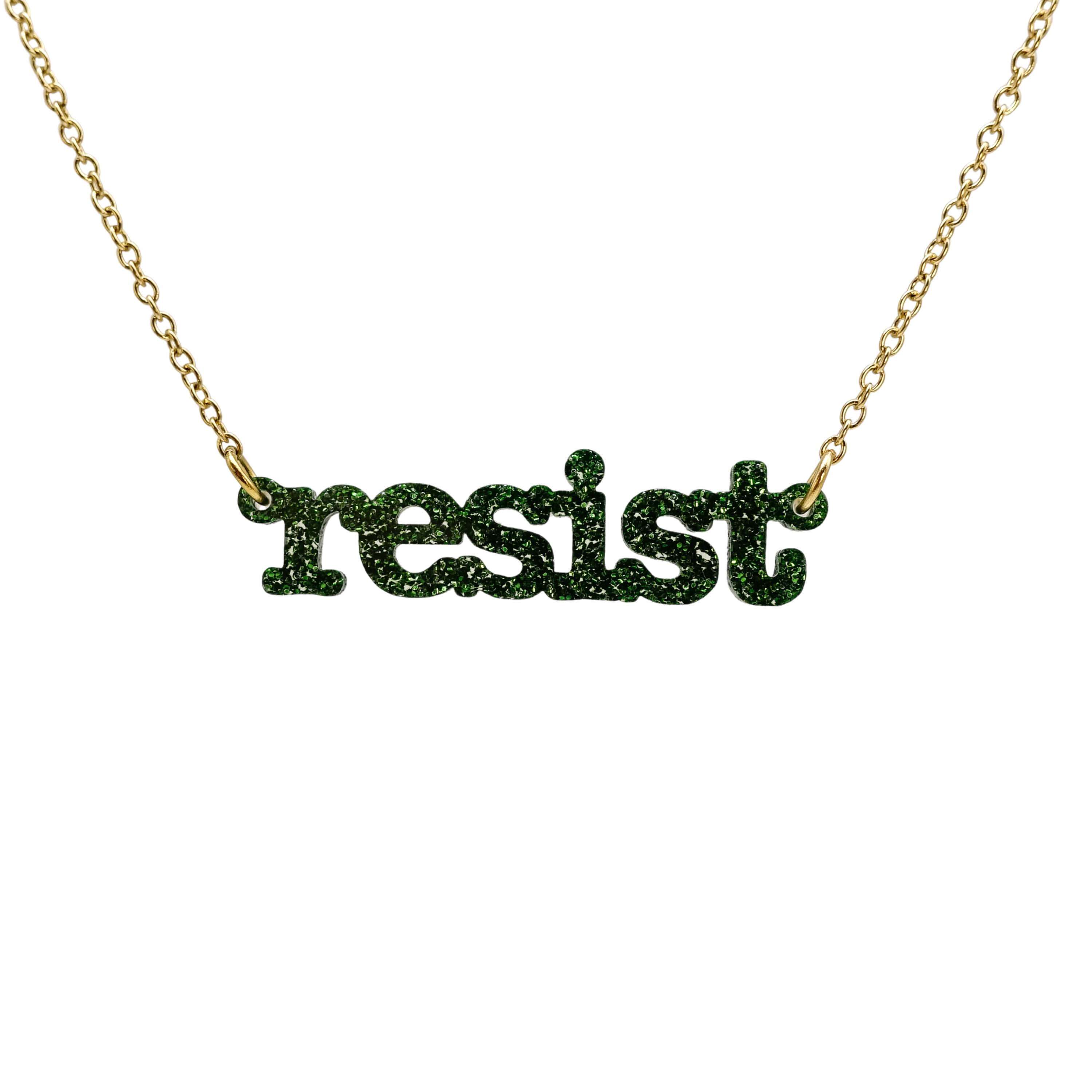 Typewriter Resist necklace in moss glitter shown hanging on a gold plated chain against a white background. 