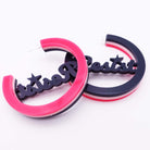 Resist and Persist statement hoops in Record Collection, shown with one upside down. 