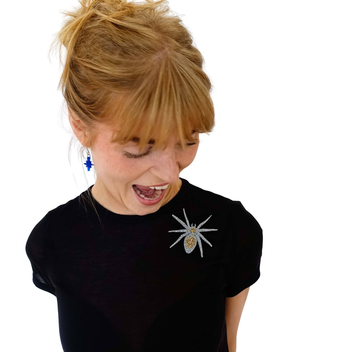 Eliza wears a spider brooch