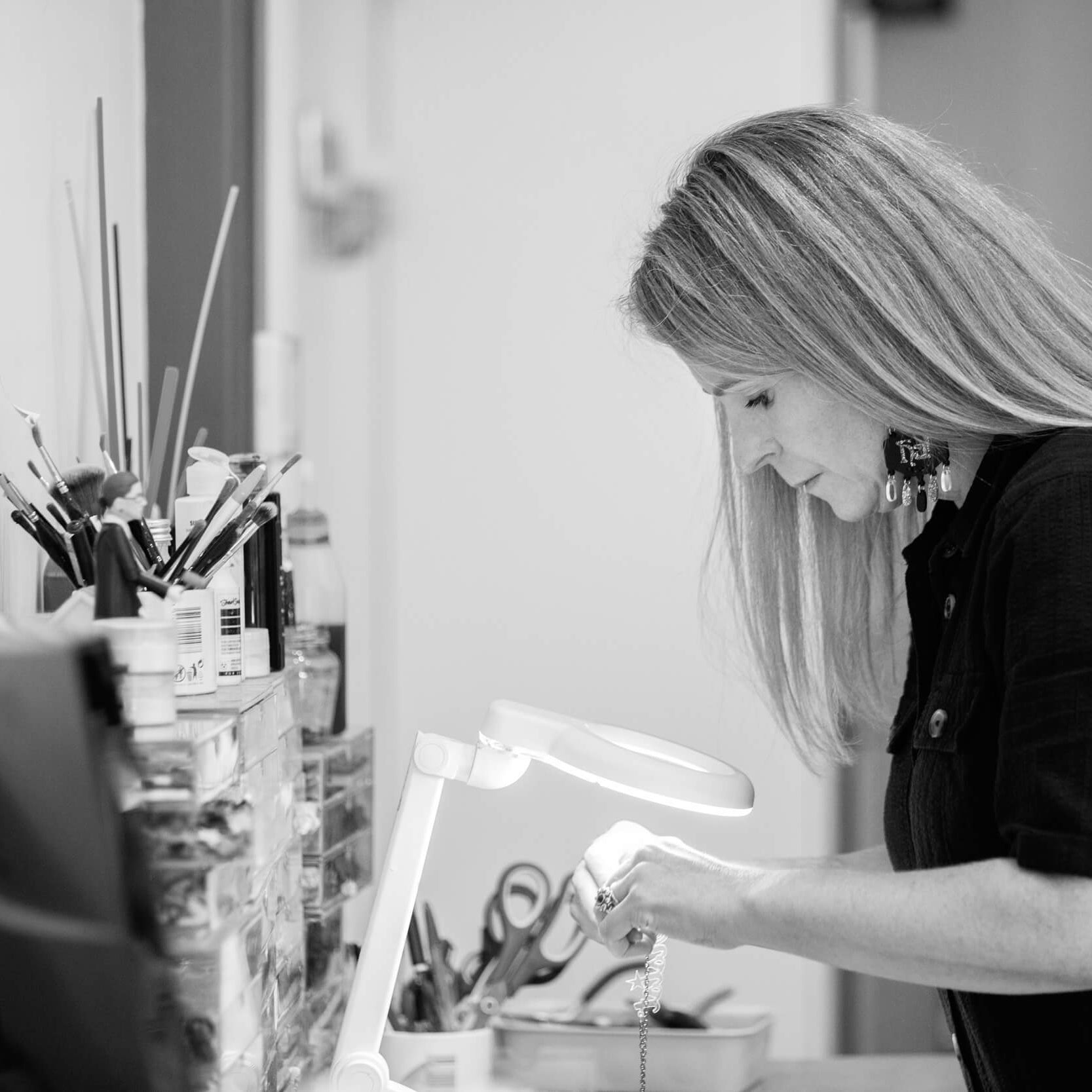 Sarah Day, founder of Wear and Resist, at her jewellery bench in her Oxfordshire studio. 