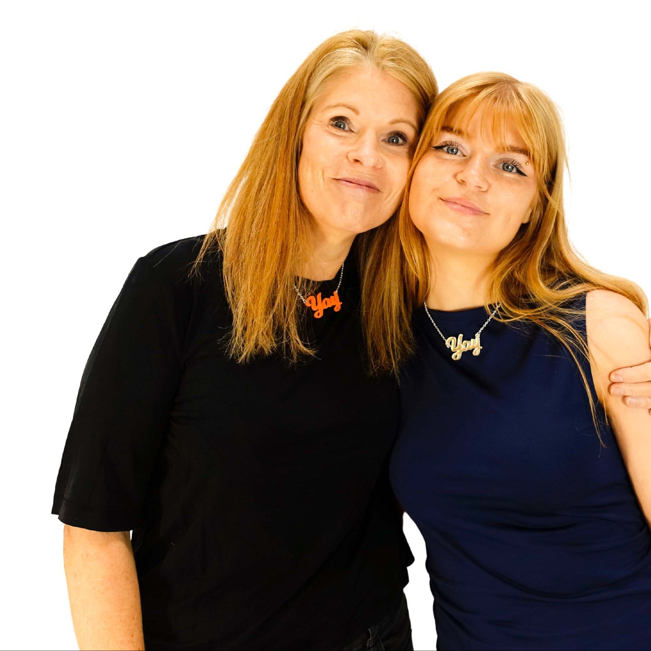 Sarah and Eliza both wearing Yay necklaces in orange and matte iridescent. 