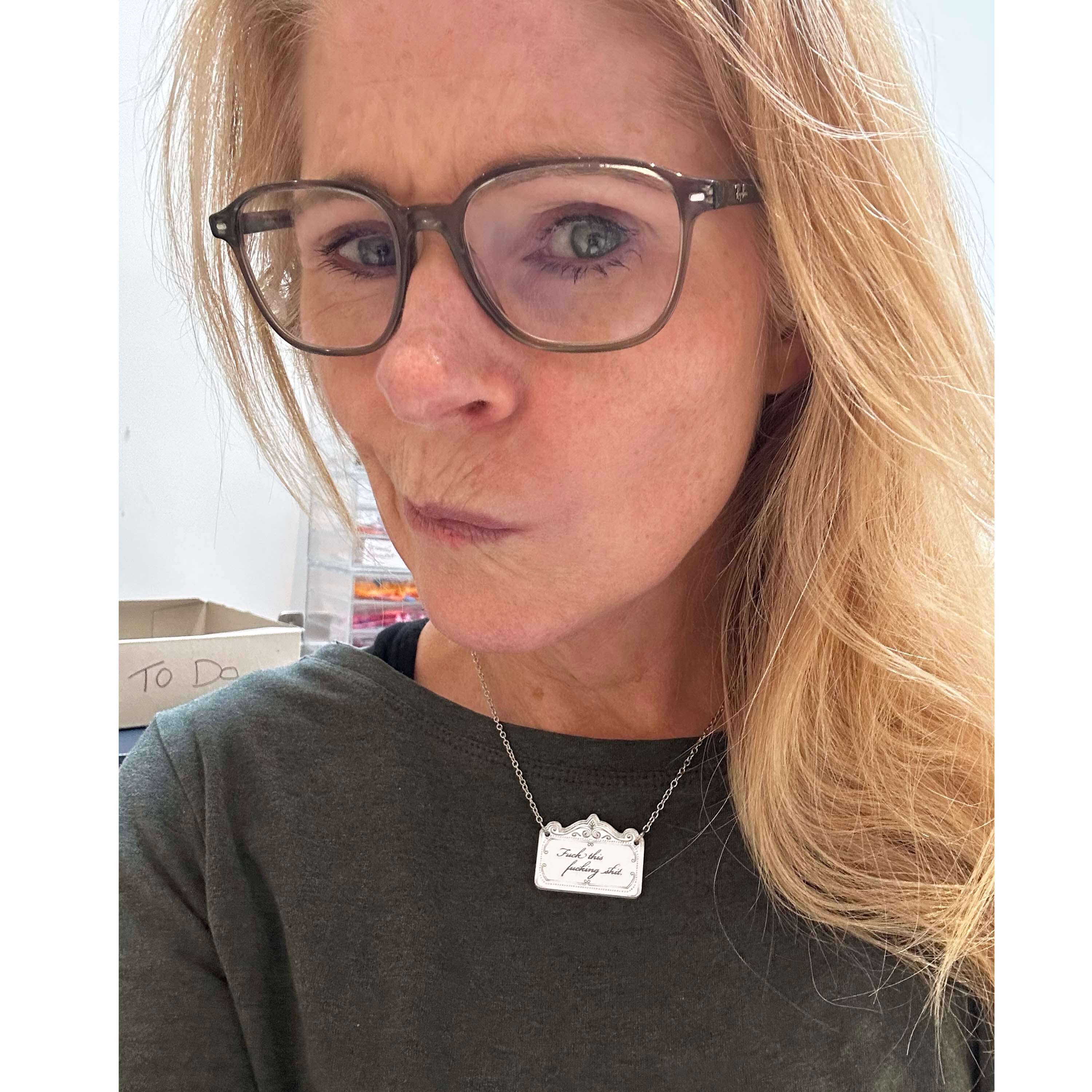 Sarah wears a small sweary necklace. 