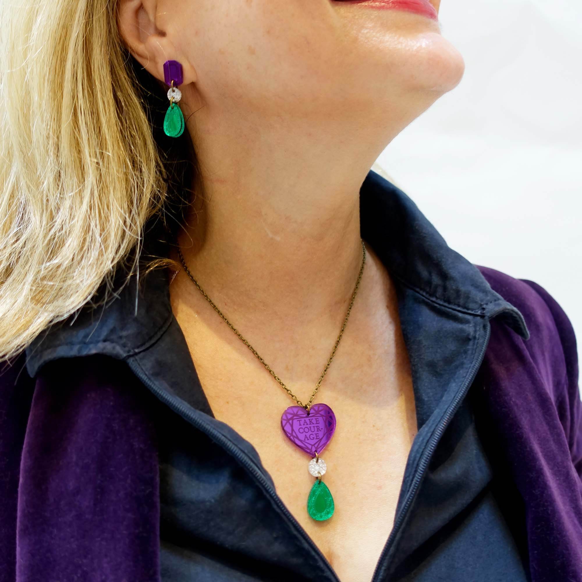 Andrea wears the Take Courage heart drop necklace with Suffragette drop earrings. 