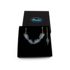 This Too Shall Pass floating clouds necklace shown on an 18K gold ion-plated stainless steel chain in a Wear and Resist gift box.
