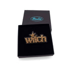 Witch brooch in gold glitter, shown in a Wear and Resist gift box. 