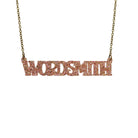 Wordsmith necklace in pink fizz glitter shown hanging against a white background. 