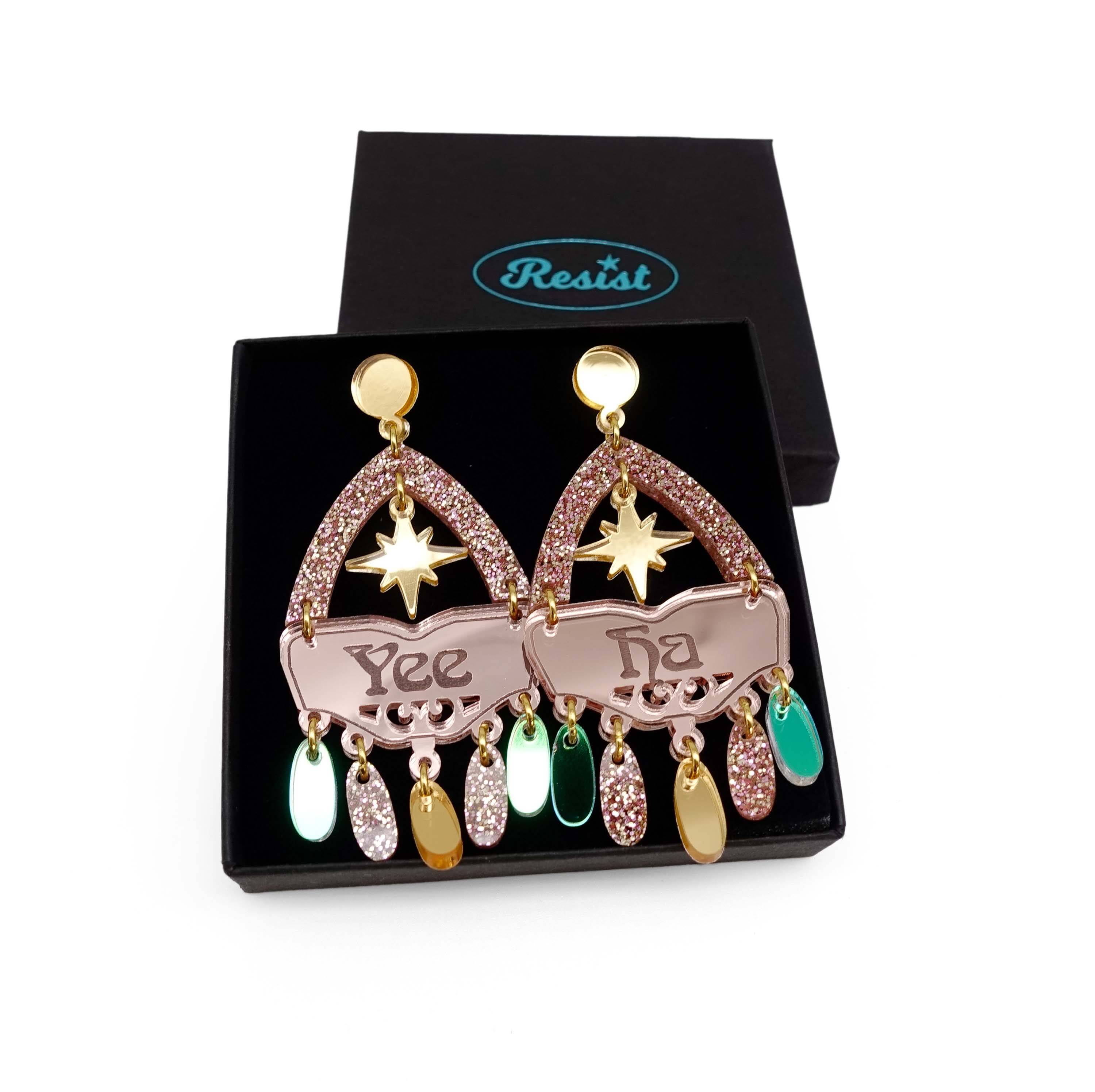 The rosey gold colourway of Western inspired Yee Ha earrings in rose gold, gold, pink fizz glitter and iridescent. Shown in a Wear and Resist gift box. 