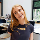 Eliza wears a massive C*nty necklace in matte iridescent in the studio. 