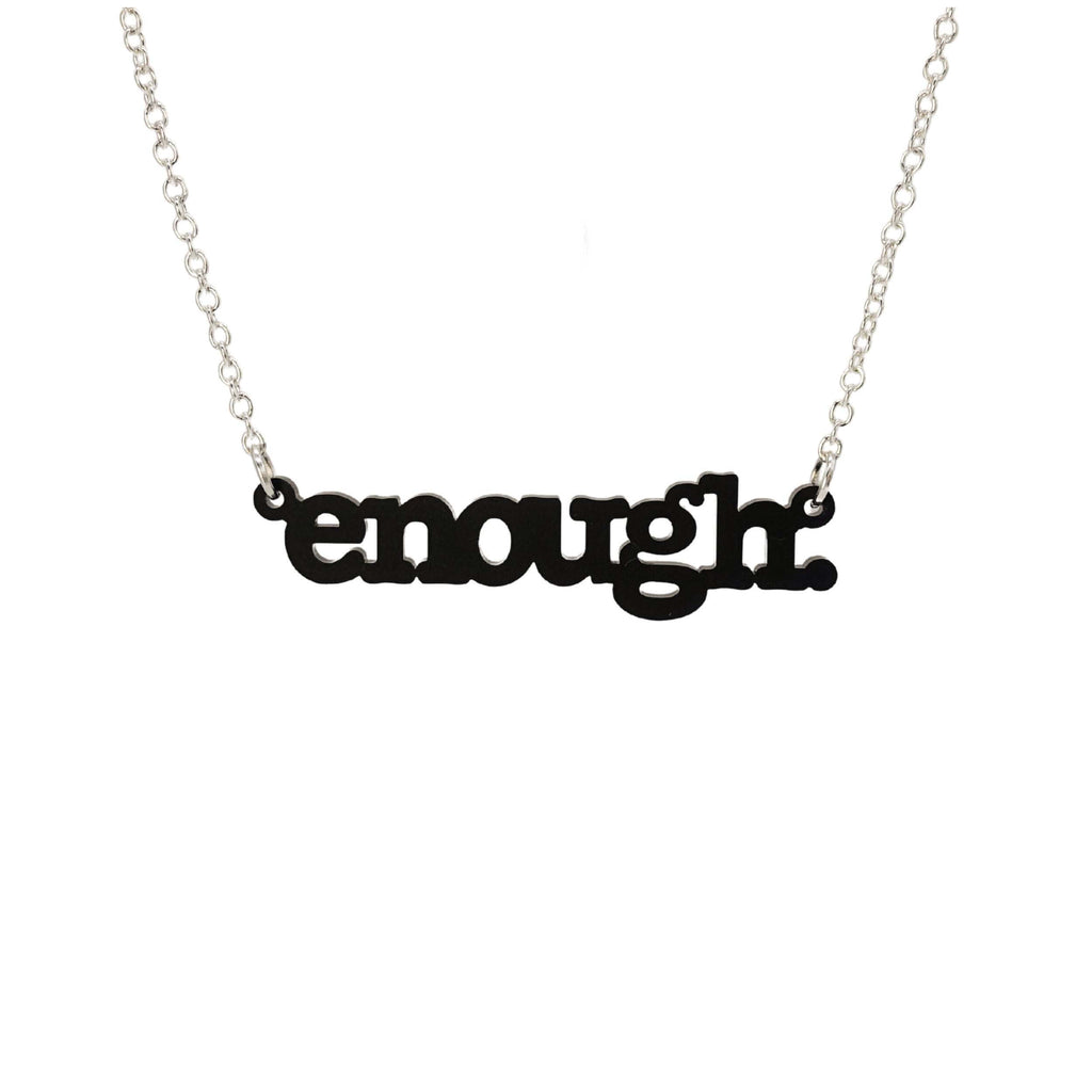 Matte black Enough necklace shown hanging on a silver chain against a white background. 