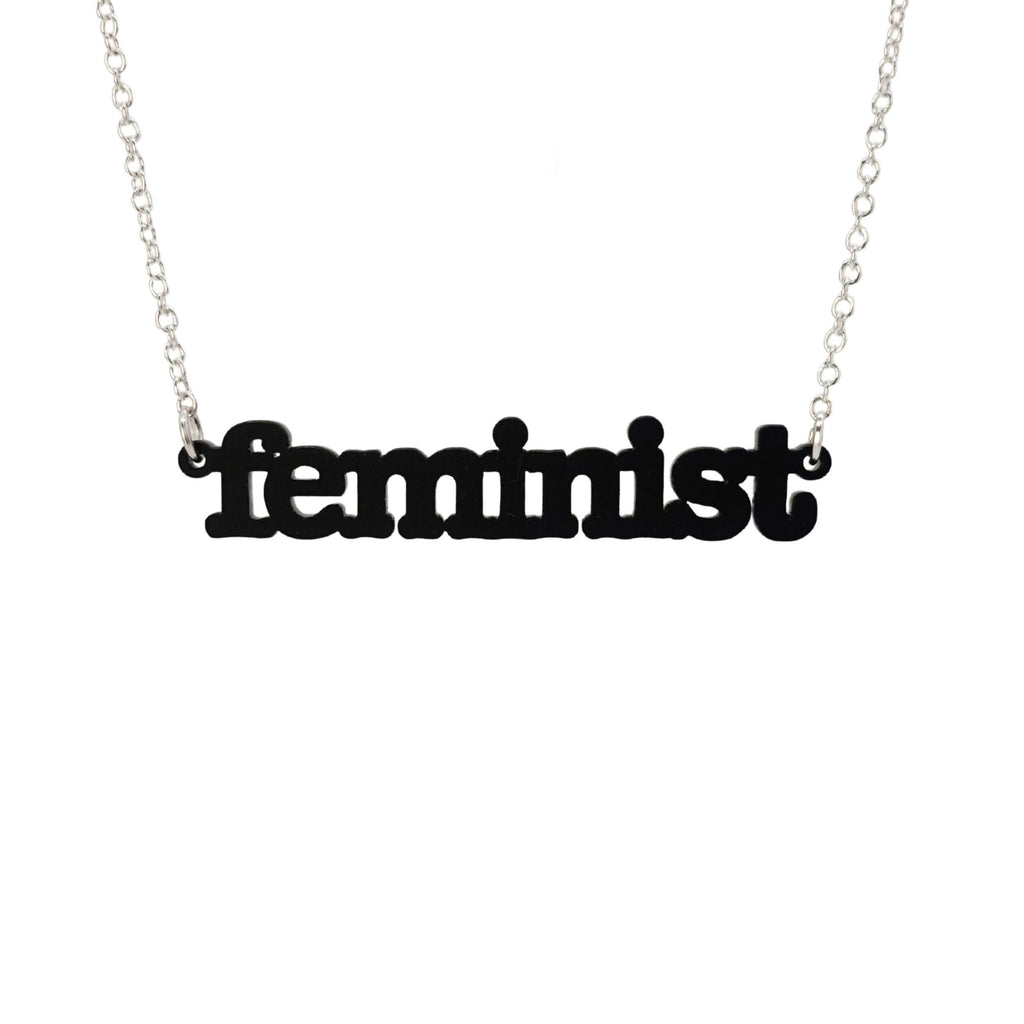 Matte black  Feminist necklace shown hanging on a white background. 