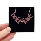 Hold Fast necklace in blush frost shown held up in a Wear and Resist gift box. 
