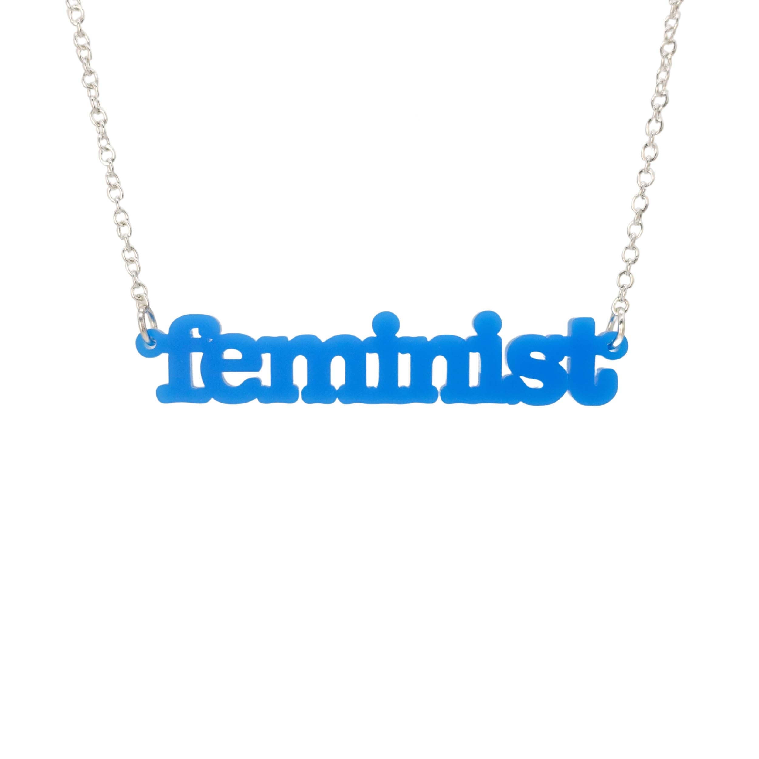 Bright blue Feminist necklace shown hanging on a white background. 